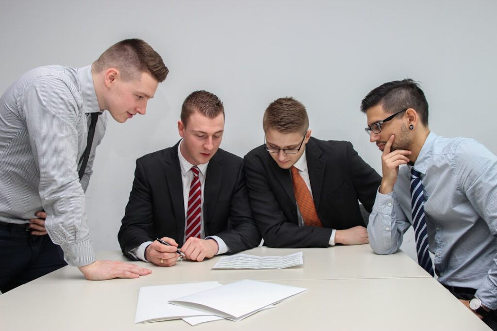Executive team reviewing documents during a complex project and transaction process